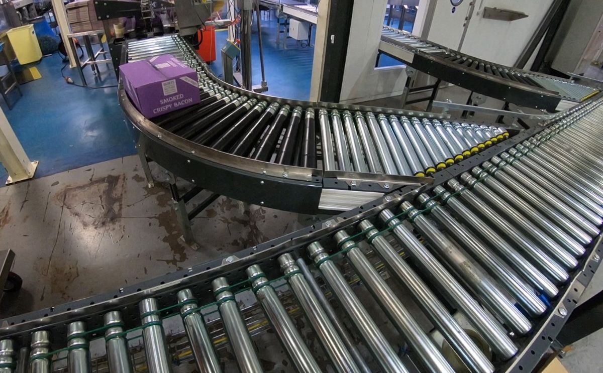 Cases of potato products from 8 production lines enter the system on roller conveyors