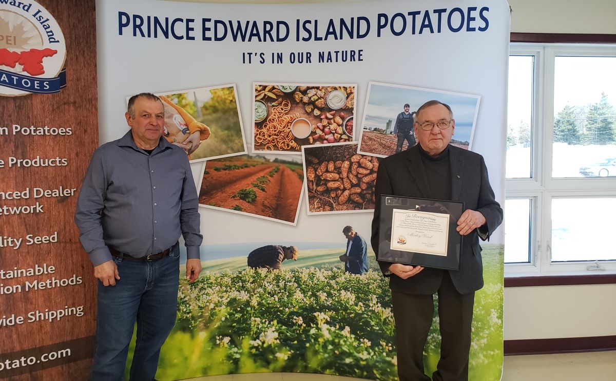 PEI Potato Board Director Donald Stavert (left) presents Potato Industry Recognition Award to Morley Wood (right)